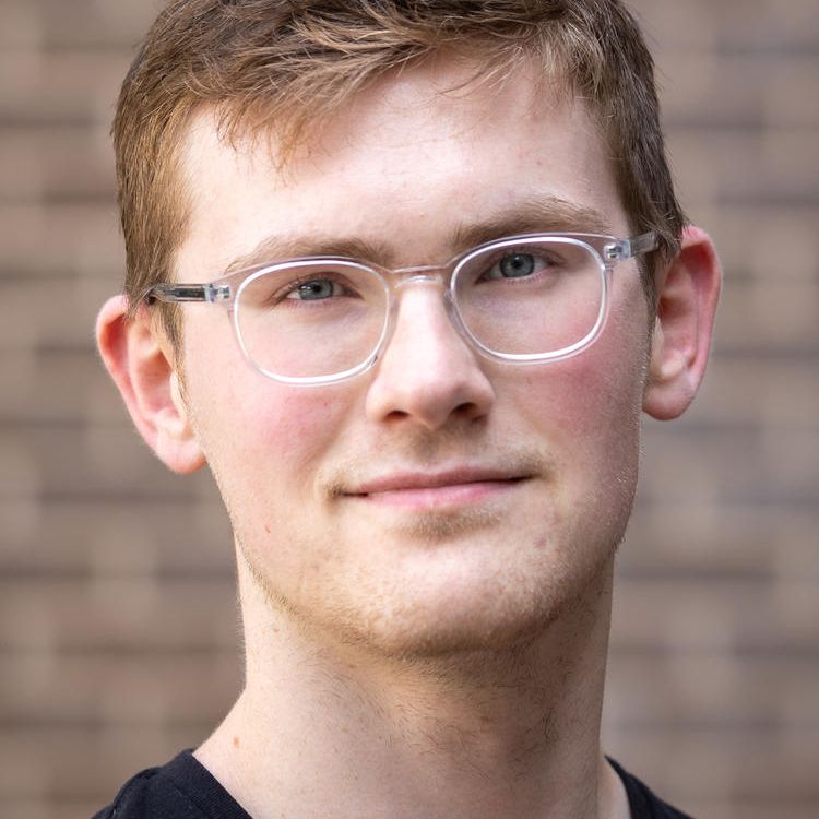 Professional headshot of a man. 