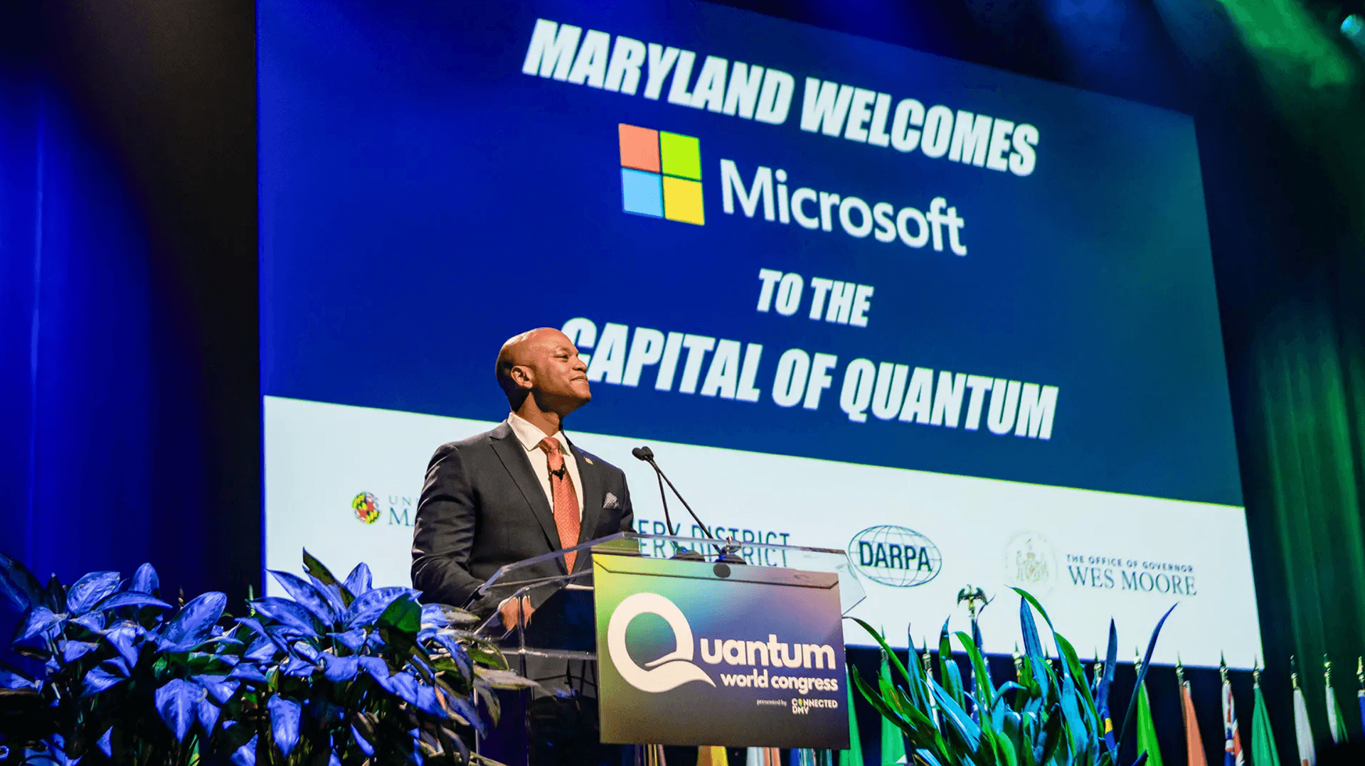 Maryland Gov. Wes Moore stands at podium in front of Microsoft and Capital of Quantum sign