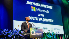 Maryland Gov. Wes Moore stands at podium in front of Microsoft and Capital of Quantum sign