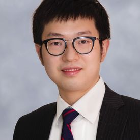 Professional headshot of a man. 