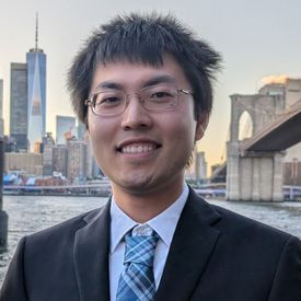 Professional headshot of a man. 