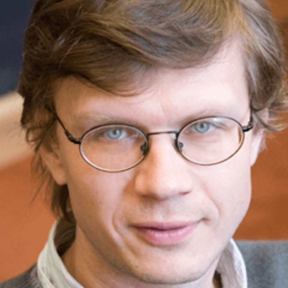 Professional headshot of a man. 