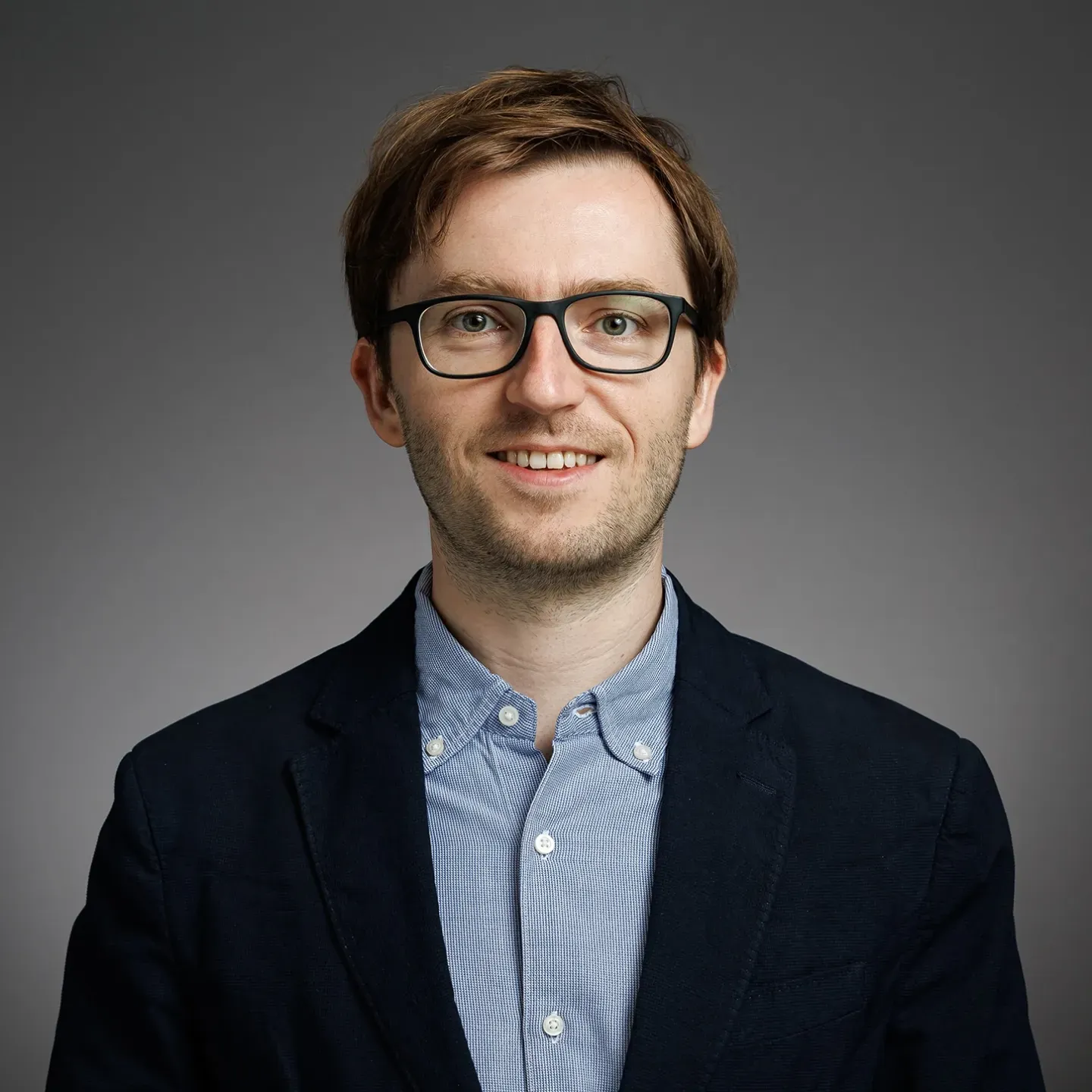 Professional headshot of a man. 