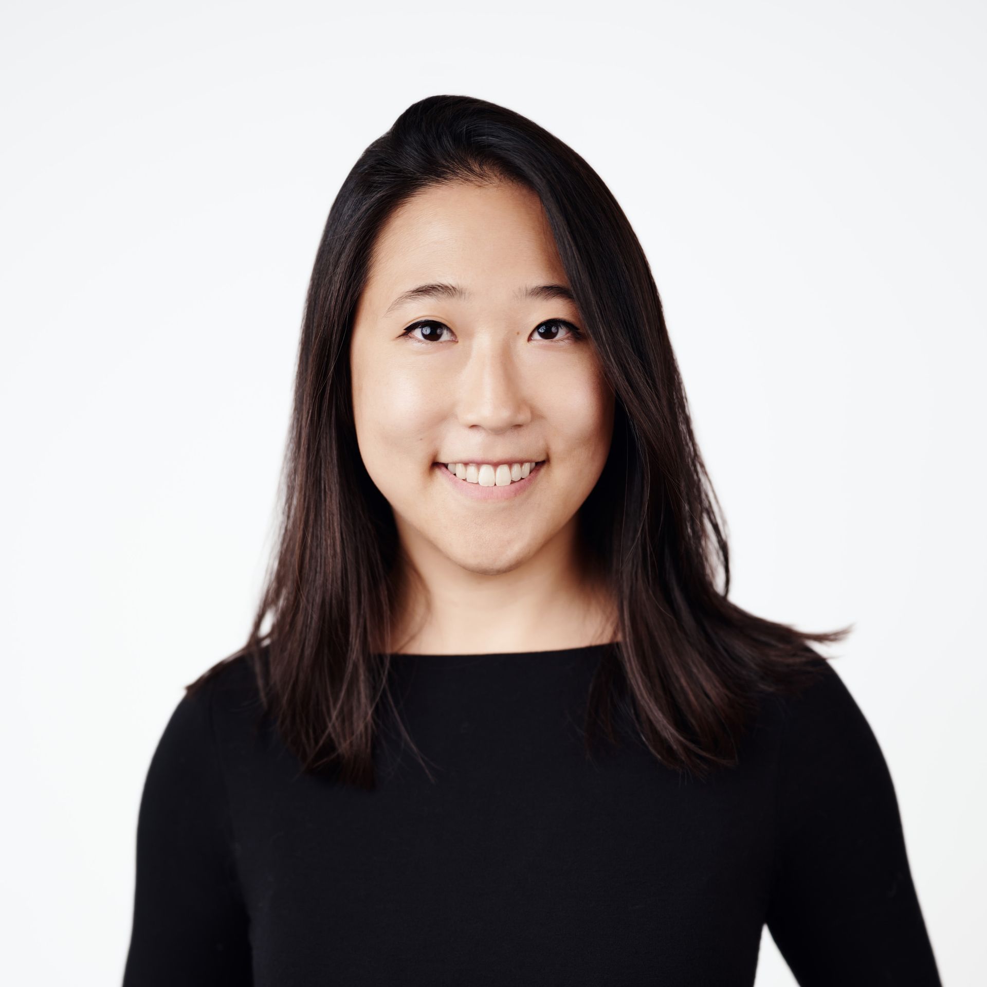 A professional headshot of a smiling woman